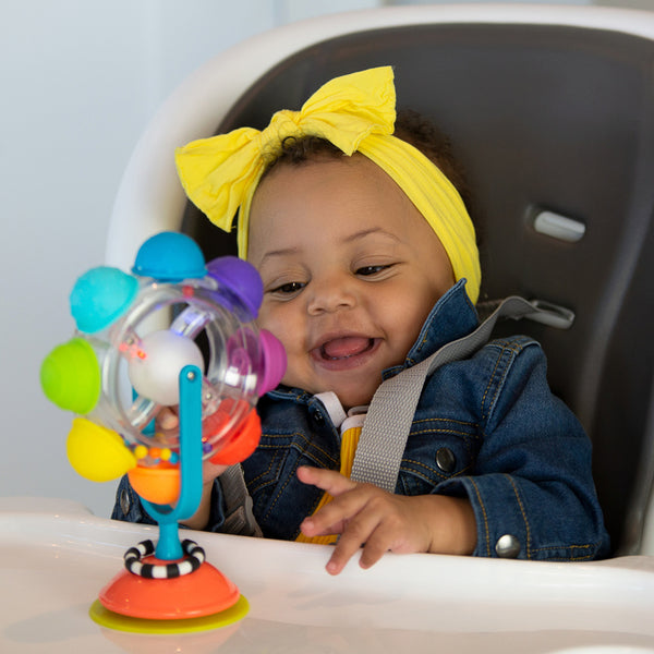 a baby laughing at the sassy baby light up rattle wheel