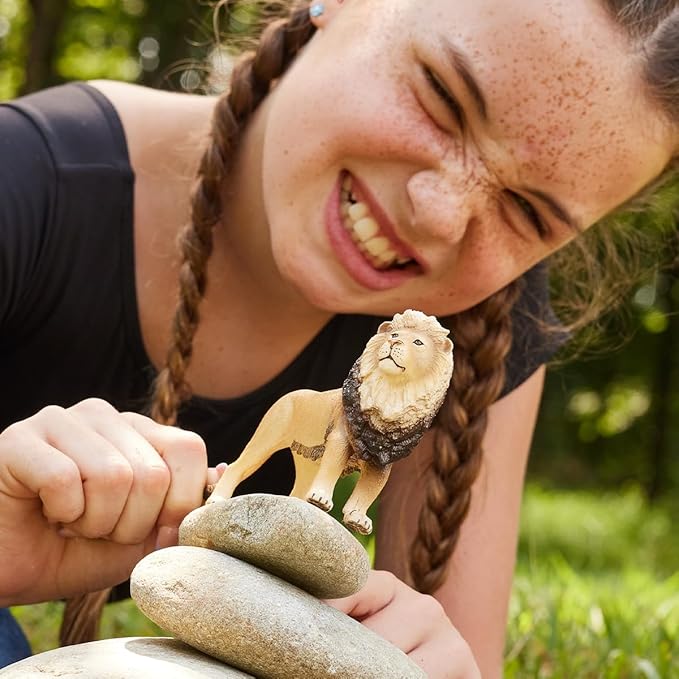 girl plays with her schleich lion figurine 